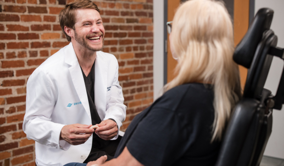 Dr. Jackson Blackburn smiling and laughing while consulting with a patient.